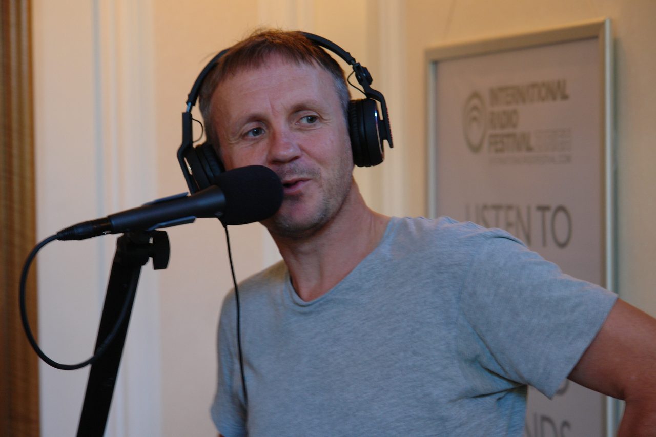 Chris Coco at the microphone wearing headphones