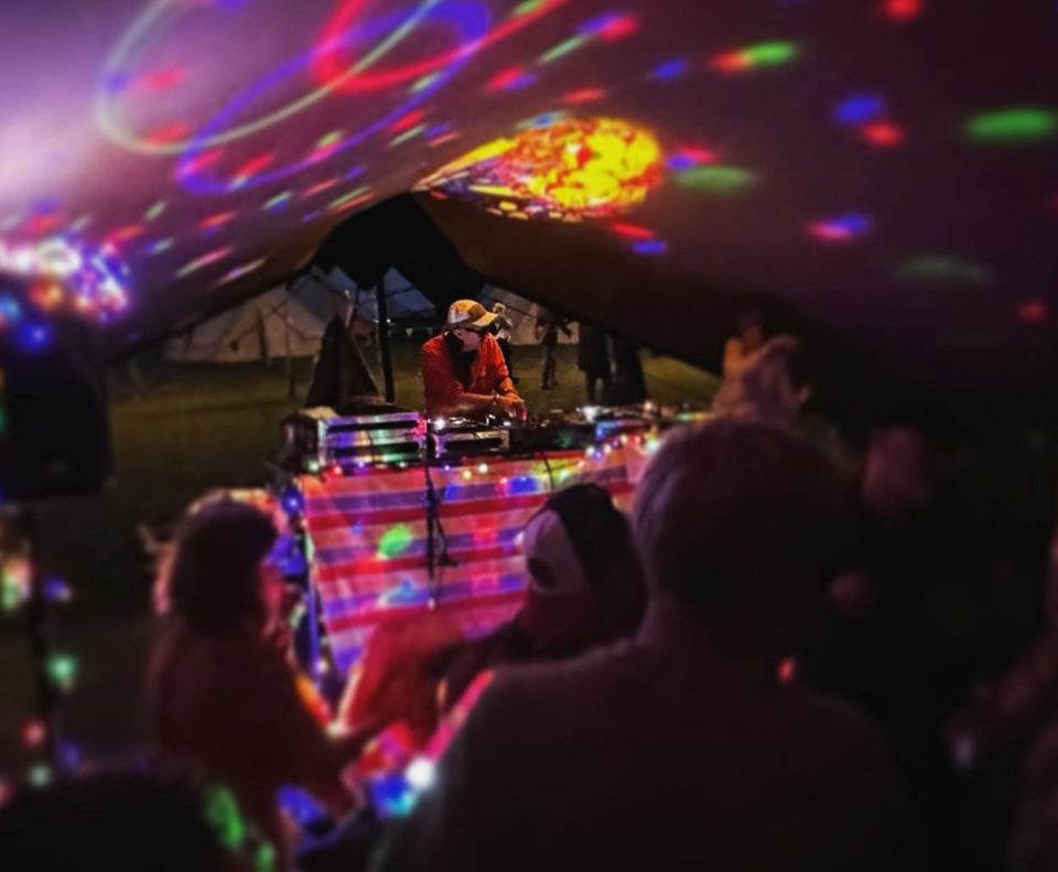 The DJ booth under disco lights in The Chill Out Tent at We Are Love 2023