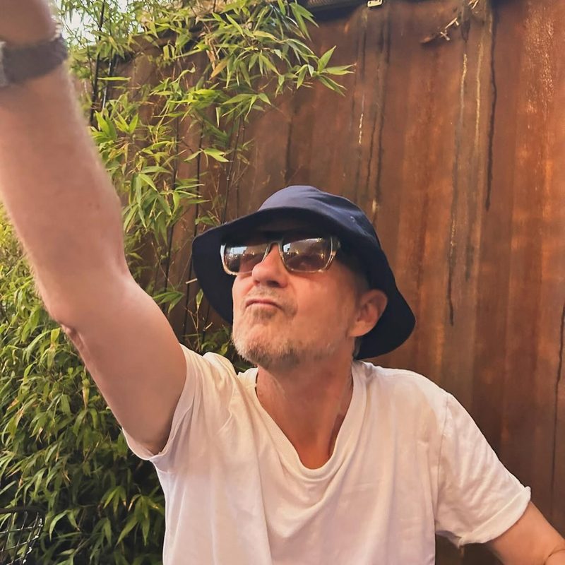 Chris Coco in a navy bucket hat and sunglasses